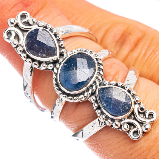 Silver ring with three oval blue sapphire-style stones in ornate bezel settings