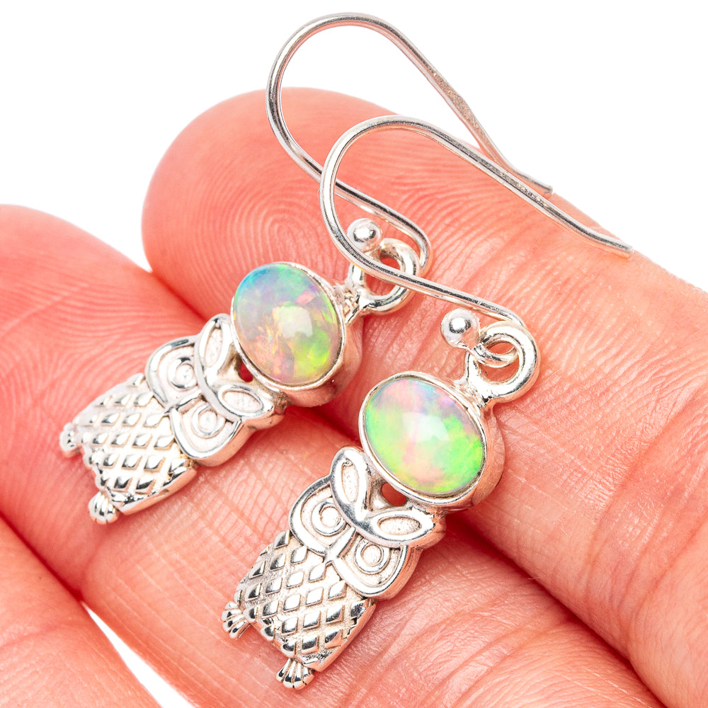 Sterling silver owl earrings with iridescent oval opal-style stones and detailed charms