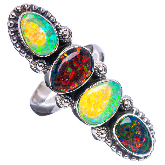 Oval opal-look stones on a sterling silver ring, ornate bezel with green and red hues.