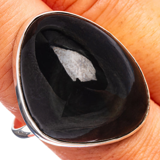 Sterling silver ring with dark oval obsidian cabochon in a polished bezel.