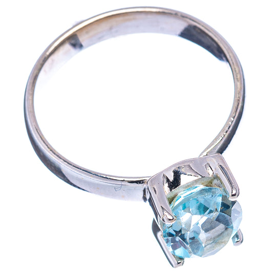 Sterling silver ring with oval faceted blue topaz and angular prong setting, side view