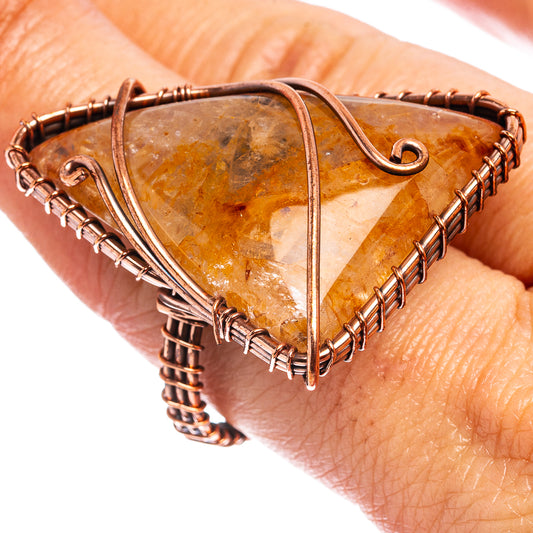 Oxidized copper wire-wrap ring with amber rutilated quartz teardrop cabochon.