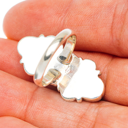 Sterling silver ring side view with openwork clover-shaped band and prong setting