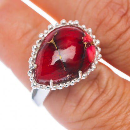 Sterling silver ring with red oval cabochon gemstone and beaded prong halo