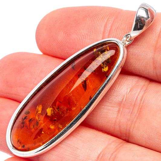 Baltic amber pendant close-up in oval bezel with .925 silver border
