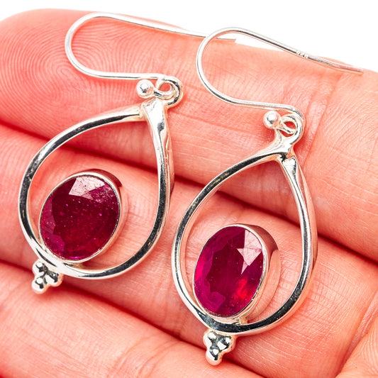 Sterling silver teardrop earrings with oval ruby-red gemstone accents