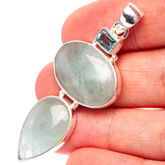 Sterling silver pendant with light blue gemstone settings and oval cabochon stones, close-up