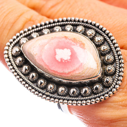 Sterling silver ring with oval pink rhodochrosite cabochon and ornate beaded setting