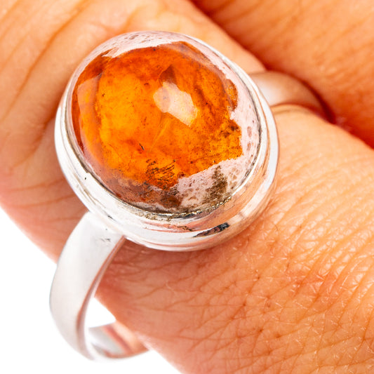Sterling silver fire opal ring close-up, orange oval cabochon in bezel