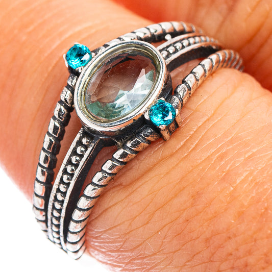 Dainty sterling silver ring with oval blue topaz center and small blue accents