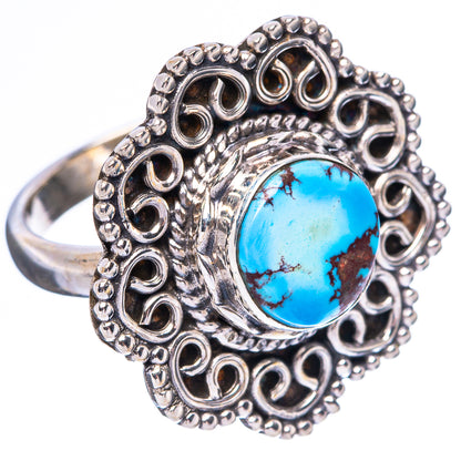 Sterling silver ring featuring blue turquoise cabochon and heart-like filigree border