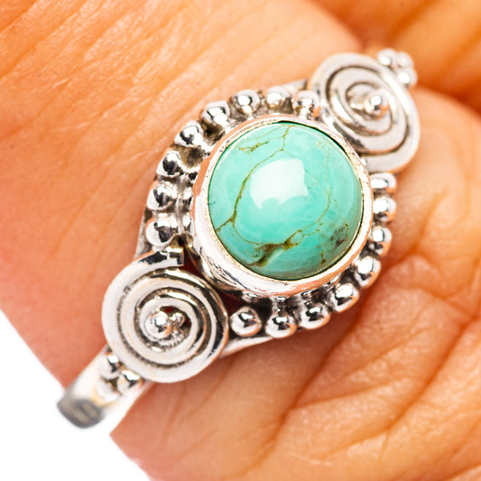 Turquoise oval gemstone sterling silver ring with beaded halo and swirl accents