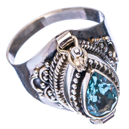 Sterling silver poison ring with oval blue topaz centerpiece and textured side details