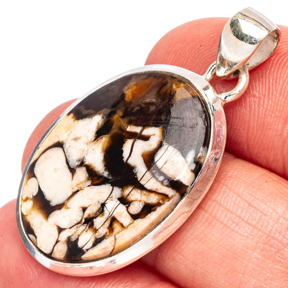 Oval jasper pendant with creamy tan and dark brown patterns in silver frame