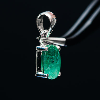 Green emerald pendant in .925 sterling silver with prongs and arched loop bail