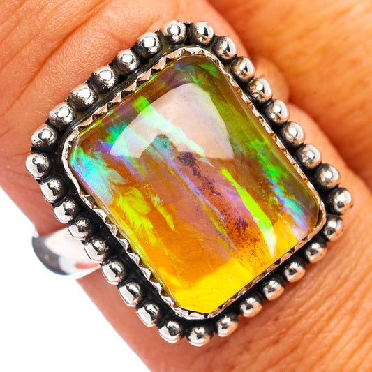 Sterling silver opal ring with cushion-cut rainbow gemstone and beaded bezel