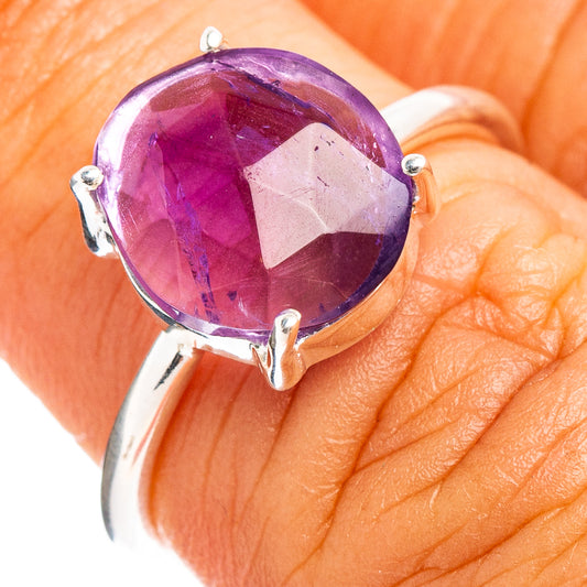 Faceted round amethyst ring with silver prong setting, close-up
