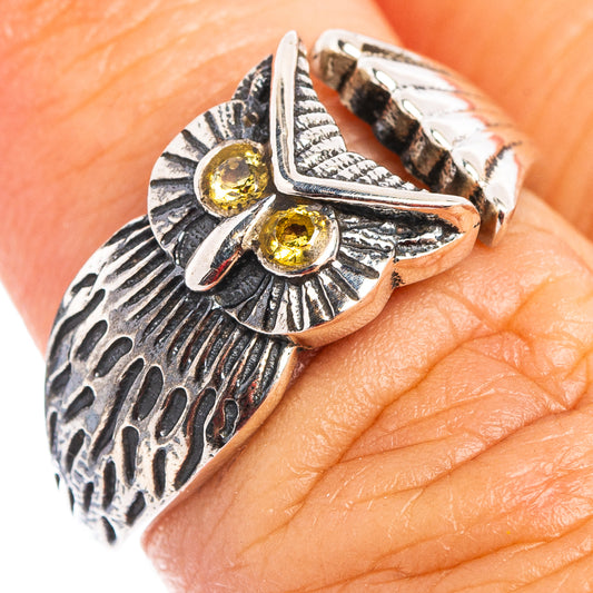 Silver owl ring with two gold-yellow citrine stones on textured feather setting