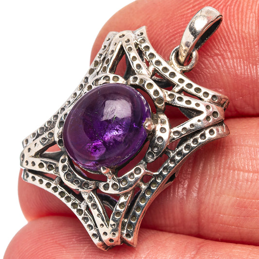 Oval amethyst pendant close-up, purple cabochon in textured .925 silver frame