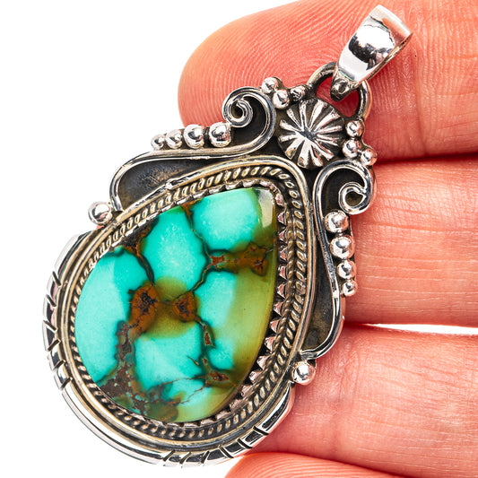 Turquoise pendant with oval stone, ornate .925 sterling silver setting and bail