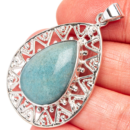 Teardrop sterling silver pendant with blue-green turquoise cabochon and ornate border