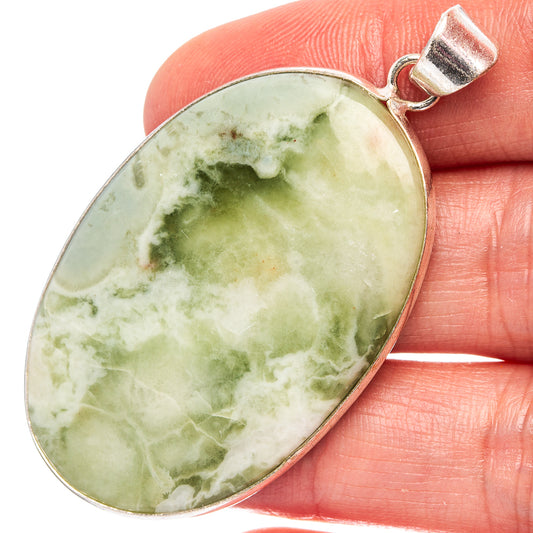 Silver-plated oval serpentine pendant, green cabochon stone with bail loop