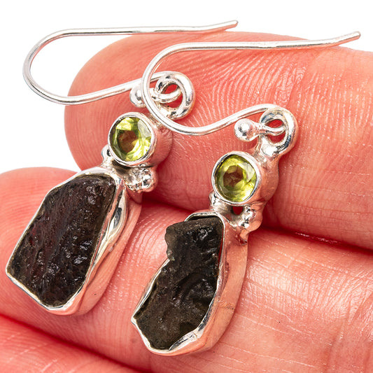 Sterling silver dangle earrings with round peridot-green stones and dark rough teardrops
