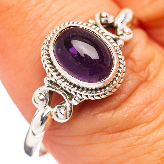 Sterling silver ring with oval amethyst center and braided rope halo