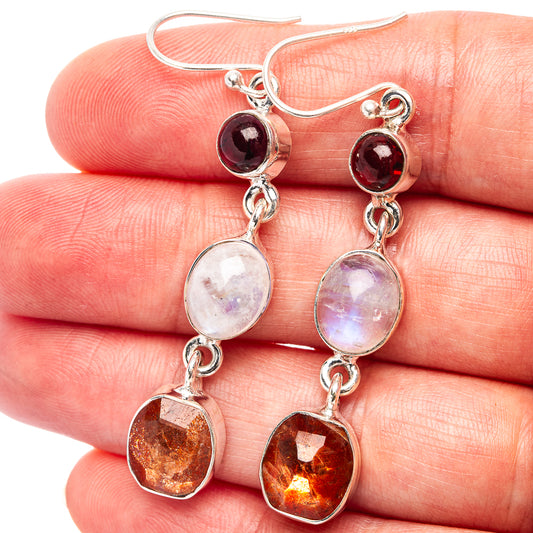 Sterling silver drop earrings with red, iridescent moonstone, and amber-orange stones