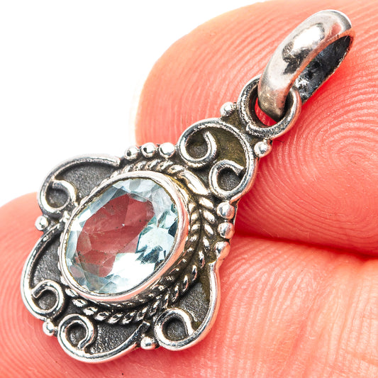 Sterling silver blue topaz pendant with oval faceted gemstone in ornate filigree bezel