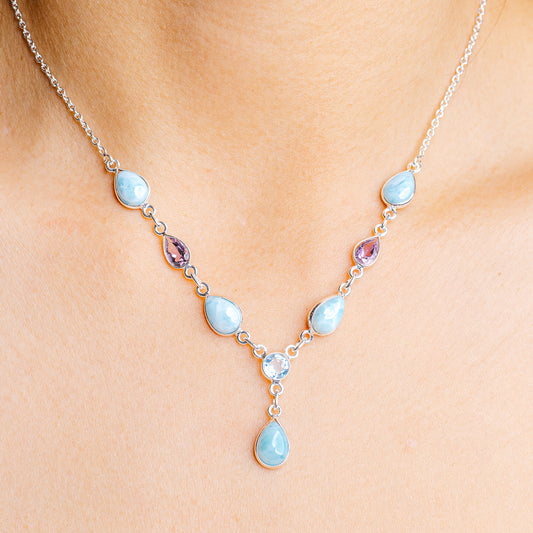 Sterling silver gemstone pendant necklace with oval blue stones and a small purple accent