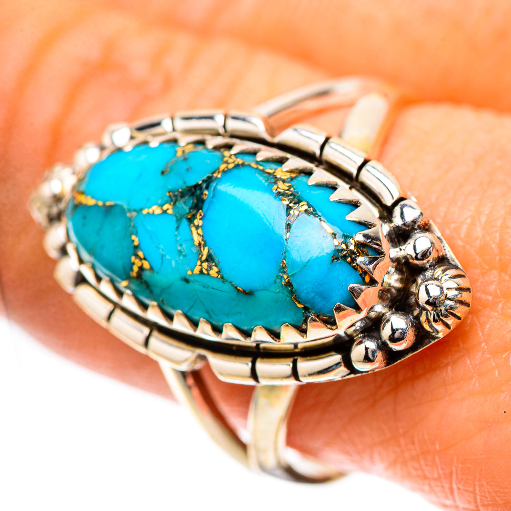 Turquoise oval cabochon sterling silver ring with raised bezel and blue stone, gold matrix