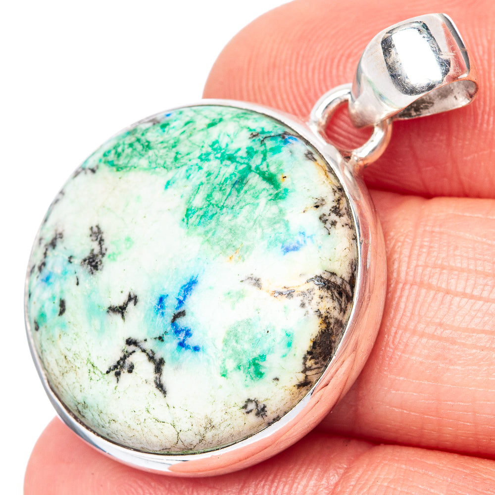Sterling silver pendant with round azurite cabochon and hinged bail, close-up.