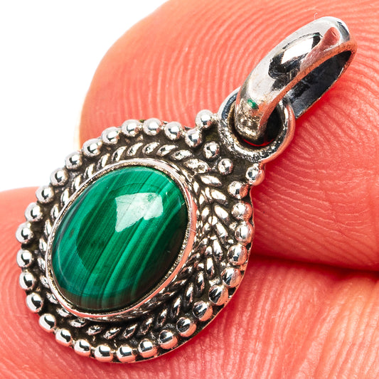 Sterling silver pendant with oval green malachite cabochon and ornate beaded rim