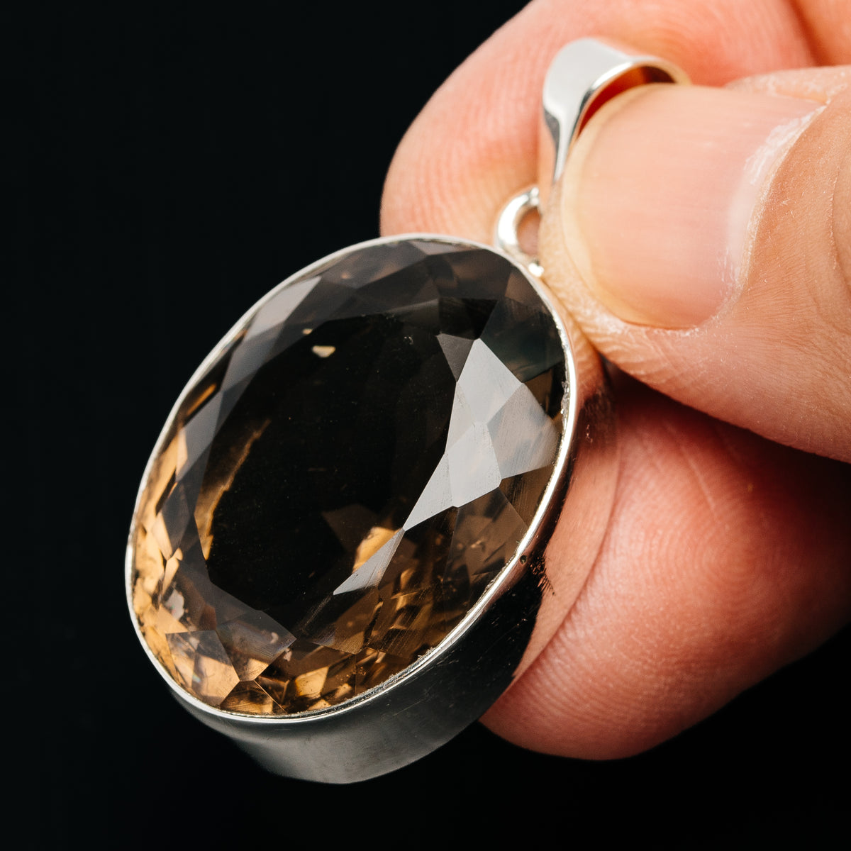 Sterling silver smoky quartz pendant with oval faceted dark stone and top loop