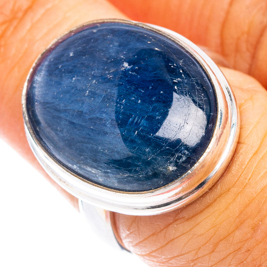 Oval blue aquamarine cabochon ring in .925 sterling silver bezel, on finger