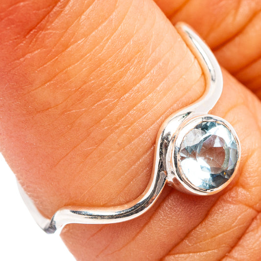 Sterling silver ring with oval blue topaz stone and wavy open band