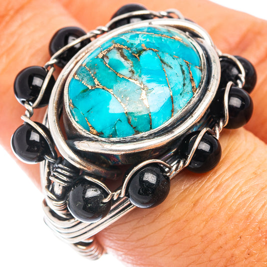 Sterling silver ring showing large oval turquoise cabochon with black onyx stones