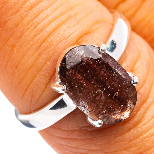 Sterling silver ring with oval dark reddish gemstone, four-prong setting, size 7