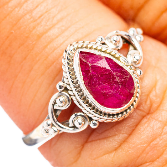 Sterling silver ring with pear-shaped red-pink gemstone and ornate filigree setting