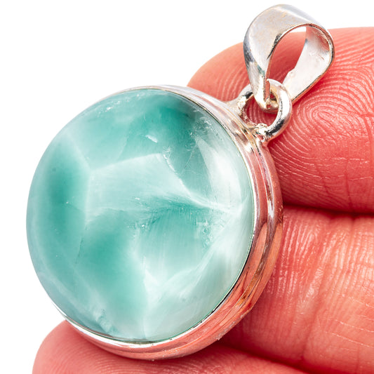 Round turquoise cabochon set in .925 sterling silver bezel with hinged bail