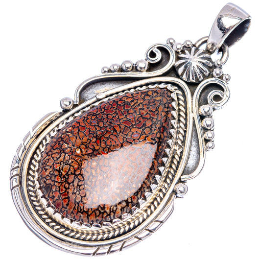 Ornate oval .925 sterling silver dinosaur bone pendant with red speckled fossil inlay