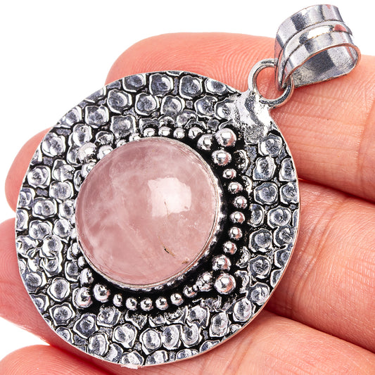 German silver rose quartz pendant with round pink cabochon and textured bezel, bail