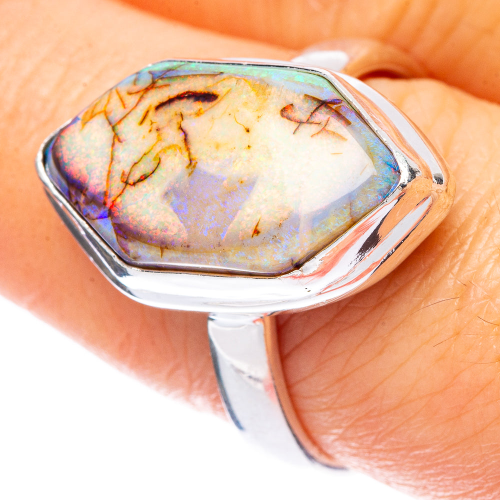 Sterling silver opal ring with pear-shaped iridescent stone, open bezel