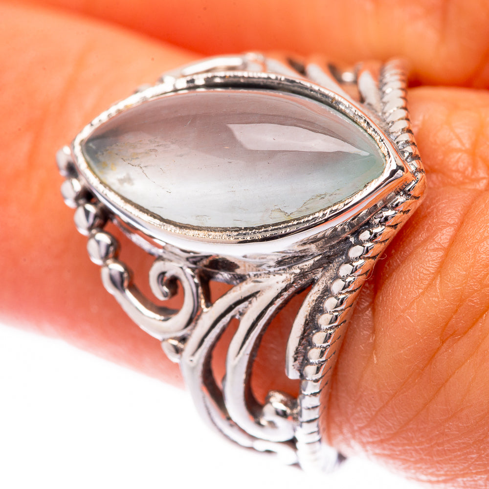 Sterling silver ring with pear-shaped light blue aquamarine and ornate side details