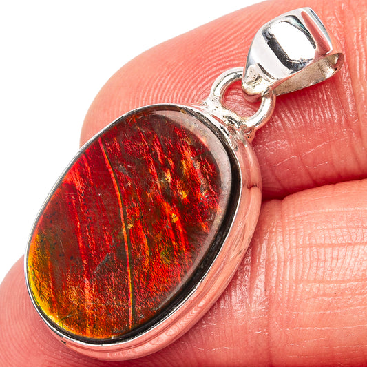 Oval ammolite pendant in .925 sterling silver bezel with vivid red-orange iridescence.