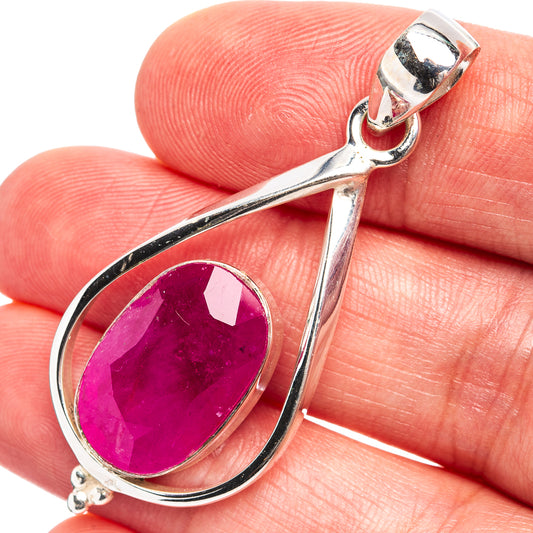 Oval magenta gemstone pendant in silver with teardrop frame and side prongs, bail