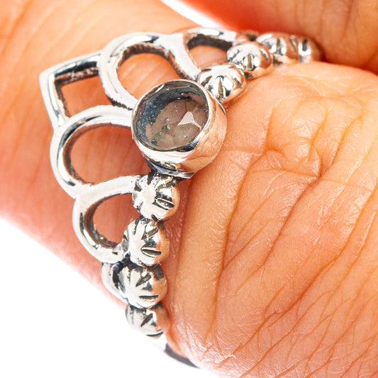 Dainty sterling silver crown ring with round aquamarine-blue stone, detailed band