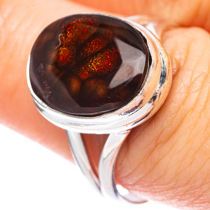 Sterling silver ring with oval dark fire agate stone and red glittery flecks