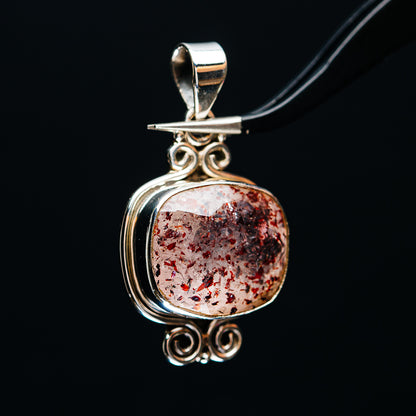 Round lepidocrocite pendant in .925 sterling silver, red flecked cabochon with swirl bail